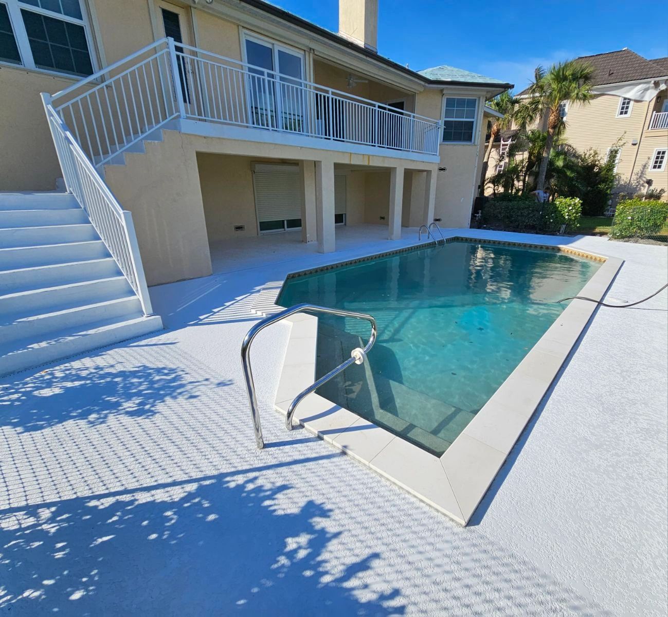 Residential pool deck with concrete patio